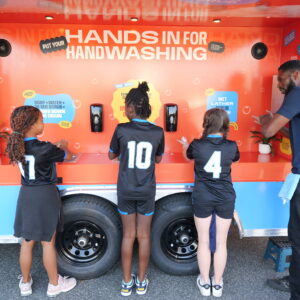 3 girls washing at Clean Hands Caravan in Washington, DC